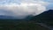 Rain and snow clouds crossing the mountains covered with native forest