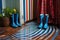 rain-soaked boots leaving water on a striped door mat