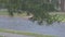 Rain water drops falling into puddle on asphalt, flooding the road floods due to the heavy rain in wet season