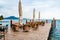 The rain wets the tables and chairs of a restaurant without customers in an Italian lake for tourists