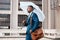 The rain wont stop me. a young businessman using an umbrella while walking through the city.