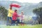 The rain wont stop them from having fun. Shot of a family having a barbecue outside in rainy weather.