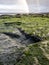 Rainbow above the famous Dinosaur footprints at An Corran beach by Staffin on the isle of Skye