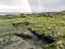 Rainbow above the famous Dinosaur footprints at An Corran beach by Staffin on the isle of Skye