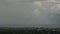 Rainbow against dark stormy clouds forming on gloomy sky before heavy rainfall over suburban area