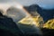 rainbow appearing behind foggy mountains