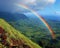 Rainbow appearing over a lush valley