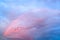 Rainbow appearing in pink color on the cloudy by sky with flock