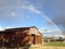 Rainbow arches over barn