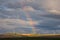 Rainbow arching above wind turbines