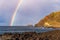 Rainbow arching out of the Atlantic Ocean at Ponta da Ferraria, Sao Miguel island, Azores, Portugal