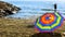 Rainbow beach umbrella on sand on the background of warm Mediter