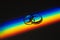 Rainbow beam on wedding rings. lgbt flag.