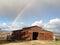 Rainbow behind barn