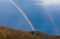 Rainbow behind mountain range, copy space