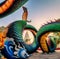 Rainbow carve serpent or colorful Thai Naga surrounding Sri Maha Pho Chedi stupa in the sunset at Wat Phra That Nong Bua