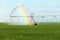 A rainbow caused by agricultural sprinkler system