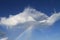 Rainbow and cloud in a blue sky