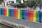 Rainbow color fence above the concrete wall