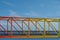 Rainbow colored bridge with ocean background - colorful steel br