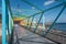 Rainbow colored bridge with ocean background - colorful steel br