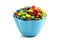 Rainbow Colored Candy Coated Chocolate Buttons in a Fun Blue Bowl Isolated on a White Background