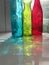 Rainbow colored glass vases, through sun glare in window