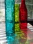 Rainbow colored glass vases, through sun glare in window