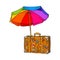 Rainbow colored, open beach umbrella and travel suitcase with luggage stickers