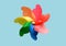 Rainbow colored pinwheel on blue background