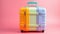 Rainbow colored suitcase isolated on color background