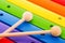 Rainbow colored wooden toy xylophone texture against white background