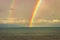 Rainbow colorful above sea horizon at dawn