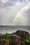 Rainbow colorful above sea horizon at dawn