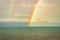 Rainbow colorful above sea horizon at dawn