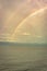 Rainbow colorful above sea horizon at dawn