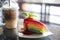 Rainbow Colorful crepe cake with strawberry sauce with cold coffee