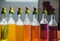 Rainbow colorful drink in bottles, yellow, orange, red, pink, purple