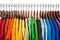 Rainbow colors, clothes on wooden hangers