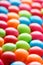 Rainbow colors of multicolored candies close-up, texture and repetition of dragee