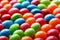 Rainbow colors of multicolored candies close-up, texture and repetition of dragee