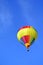 Rainbow-coloured hot-air ballon