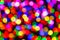 Rainbow confetti of light on black background