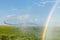 A rainbow created by an agricultural sprinkler.