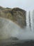 Rainbow created by mist emanating from SkÃ³gafoss waterfall, Iceland