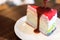 Rainbow crepe cake with strawberry sauce