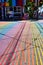Rainbow crosswalk on bright sunny day leading to Gyro Xpress storefront