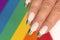 Rainbow design on long oval nails.
