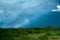 Rainbow dramatic stormy sky in blue and green colors