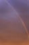 Rainbow in a dramatic sunset sky. Great scenery. Space for text. Background. Blurred. Vertical
